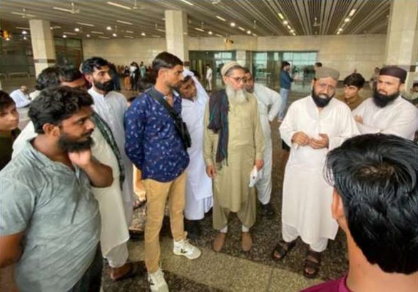 Diyar-e-Rehmat leadership briefing workers inside the airport terminal